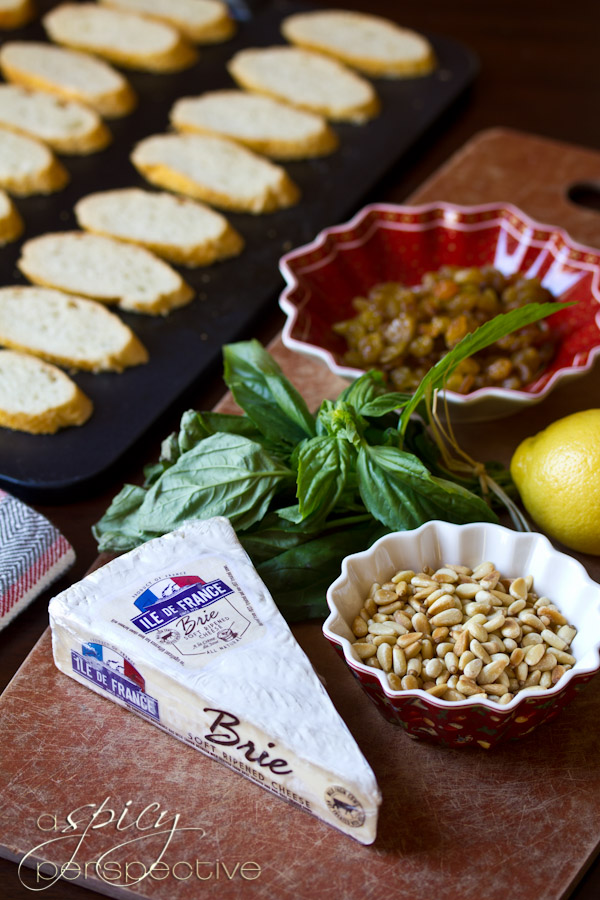 Easy Brie Toasts with Basil, Pine Nuts and Golden Raisins | ASpicyPerspective.com